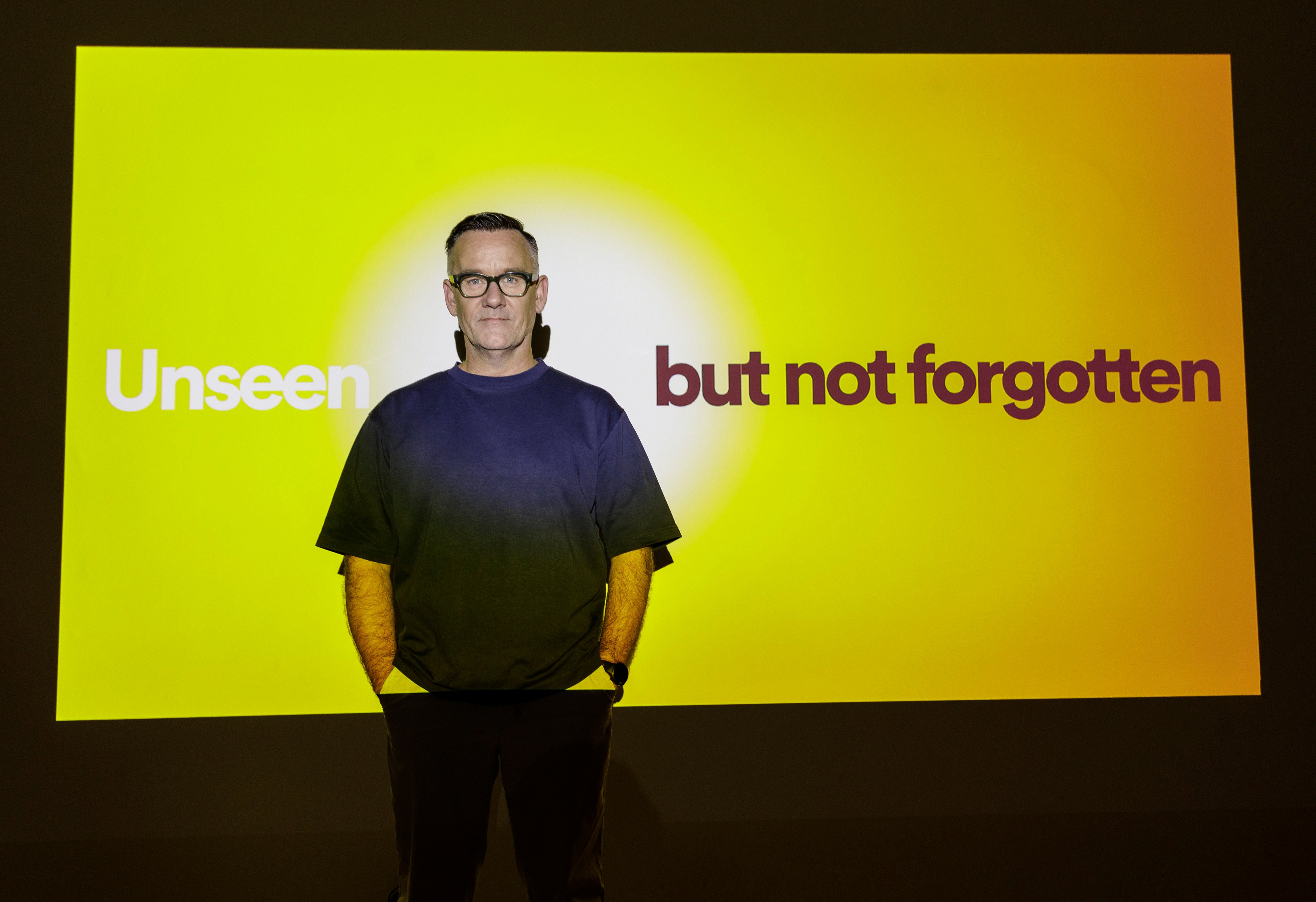 Brendan Courtney in front of Shine a Light Night billboard